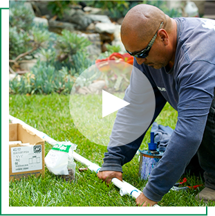 An irrigation contractor working on a Rain Bird irrigation system 