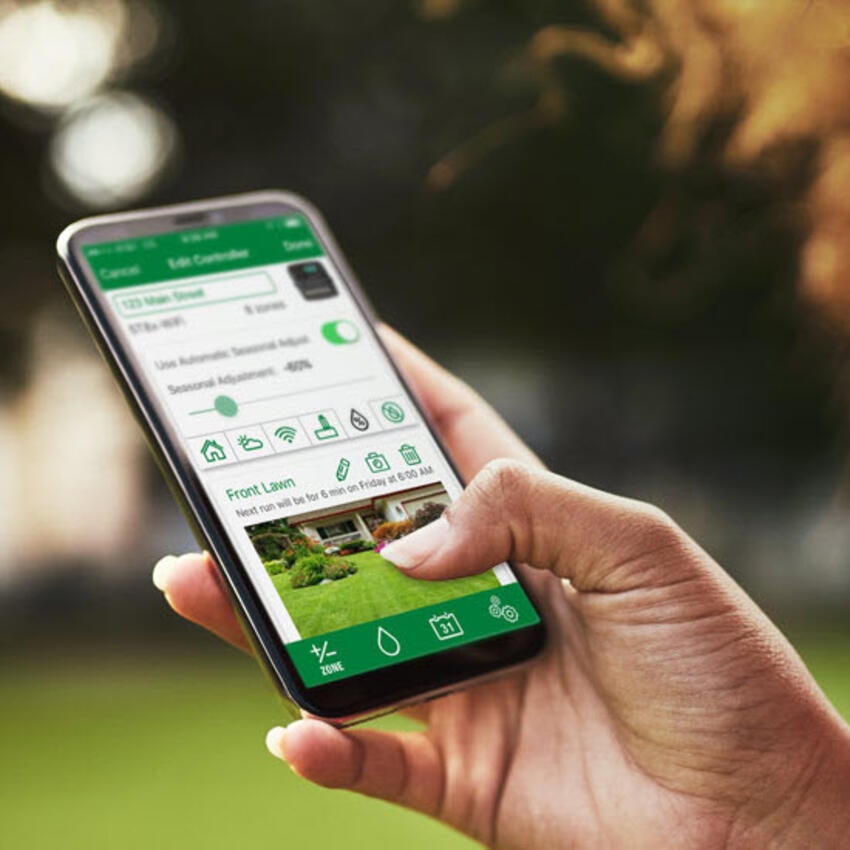 Woman holding mobile phone with Rain Bird App