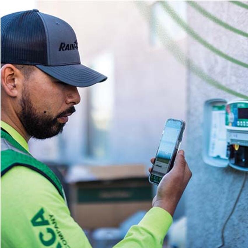 Contractor using phone to program Rain Bird controller