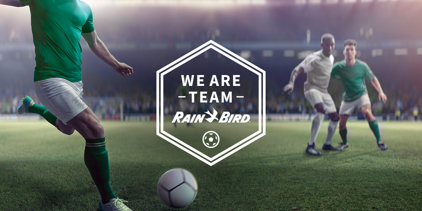 Banner of soccer player on soccer field with Rain Bird logo and slogan We Are Team