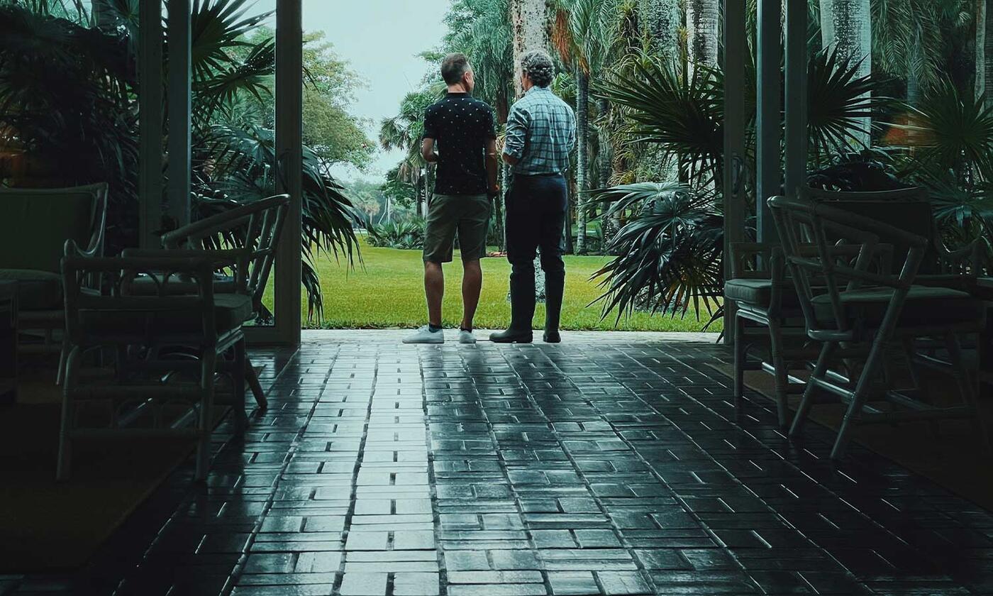 2 guys in doorway looking outside to Miami Palmetto