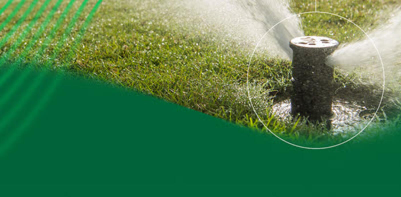 Rain Bird golf course irrigation rotor shooting water